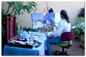 Here Jâree sits in the garden creating and painting with comfort.